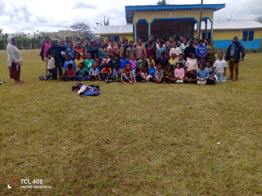 Students and teachers gathered for a group photo outside at Akaka Community School.